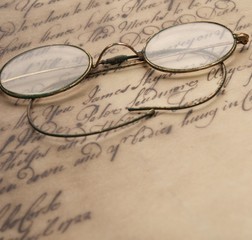 Old glasses on the vintage document