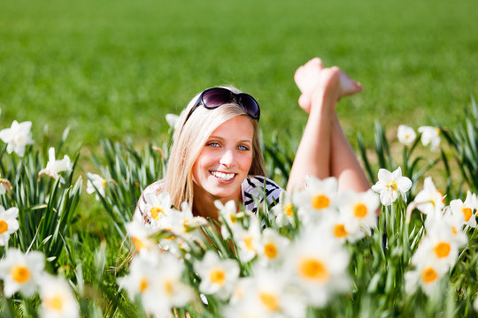 blonde junge frau zwischen osterglocken