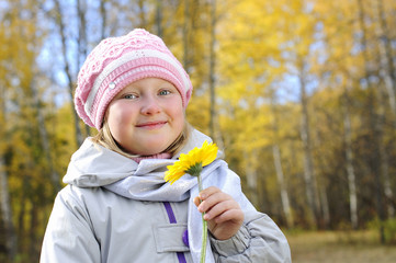 little girl with a yellow flower