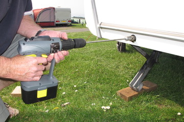 Caravan corner stays with power tool.