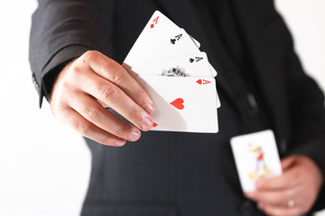 man's hand hold the four aces