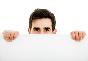 Portrait of a young guy holding blank billboard