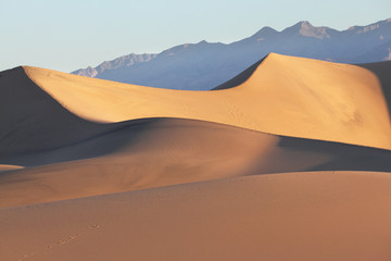 Fototapeta na wymiar Sand dunes clearly and effectively lit sunrise
