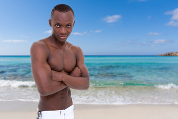 sexy man posing on the beach