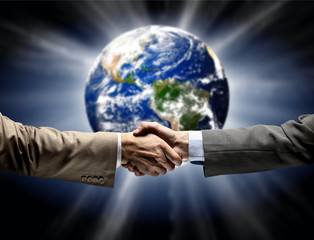 Handshake with map of the world in background