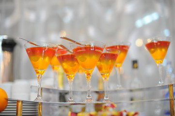 colorful jelly dessert at glasses on glass shelf