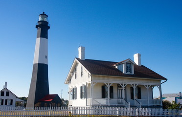 Black and White Lighthouse by White Coastal House