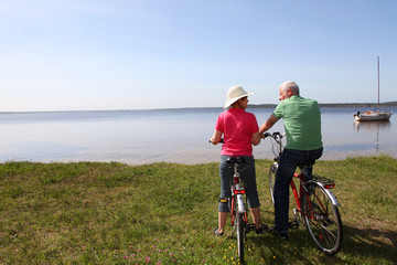 Fototapeta na wymiar Senior couple riding bicycle in summer