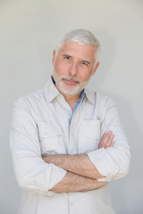 Senior man standing on white background