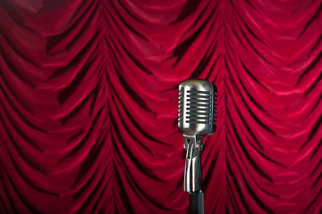 vintage microphone in front of red curtain