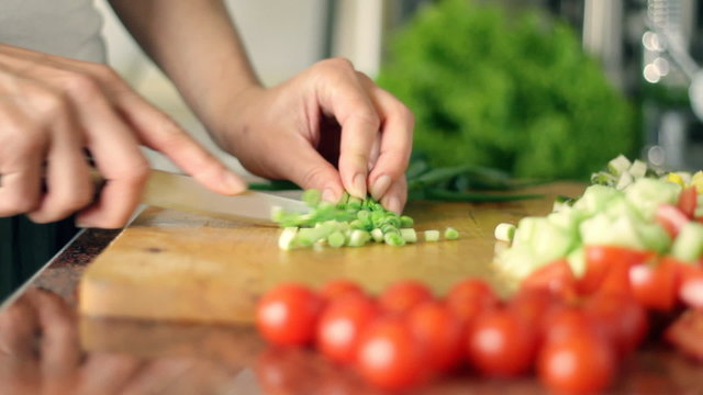 Female hands chopping vegetables