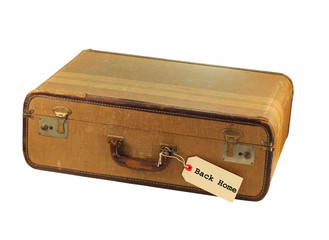 A grungy old brown suitcase with a label  