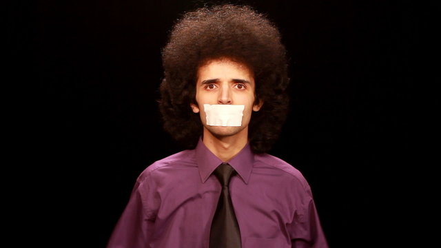young man sticking paper on his mouth