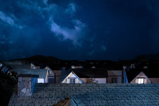 Roof Of House At Night With Houses On Background