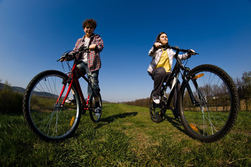 Fototapeta na wymiar Girl and boy riding bike