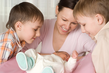 happy young mother with three children