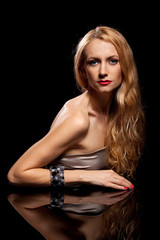 Fototapeta premium Fashion portrait of sensual young woman on black background