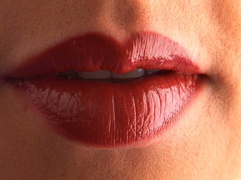Close up of young woman licking and kissing lips