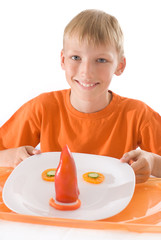 boy holding a plate with vegetables