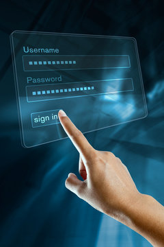 a woman hand sign in her login and password on a screen