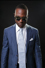 Young black man wearing suit and sunglasses