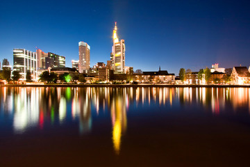 Naklejka na ściany i meble Frankfurt skyline skyscrapers at night reflecting in the river