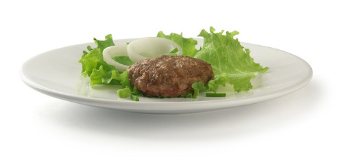 Meat rissole with lettuce on the plate