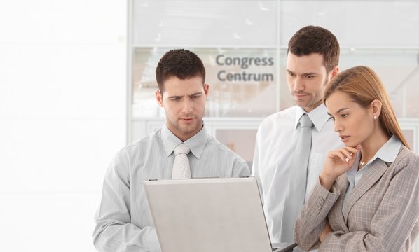 Corporate people looking at laptop screen