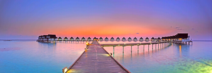 Maldives bungalows sunset panorama