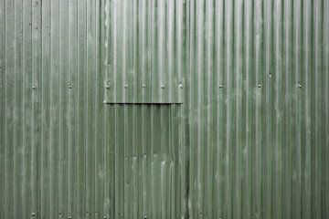 Battered corrugated metal panel