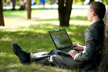 business man work on notebook at park. Student