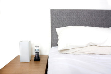 Bedside table with lamp and phone