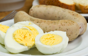 Eggs and white sausages breakfast