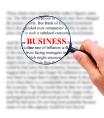 Magnifying glass in hand and word busines