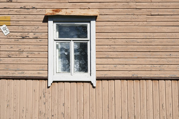 Old dirty white window in the old wooden house
