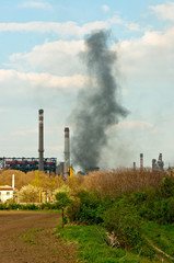 black smoke rises from power plant