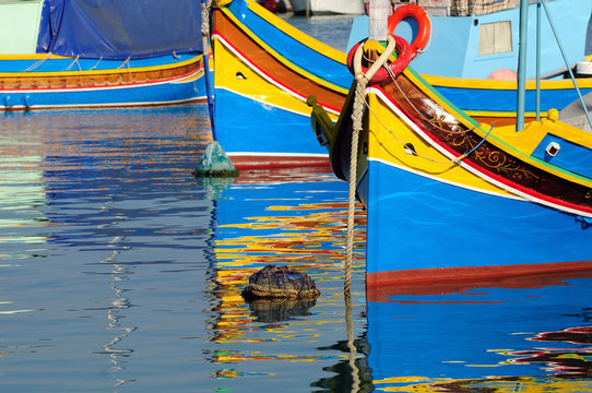 Fototapeta Traditional Maltese fishing boat with reflection