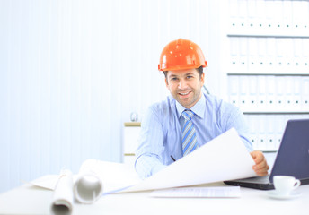 Site manager in the office with helmet