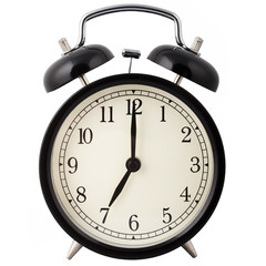 Black Alarm Clock isolated on white, showing seven o'clock