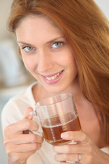 Beautiful woman holding cup of tea