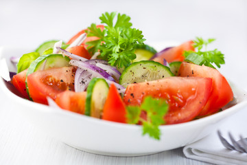 Tomato and cucumber salad with black pepper and parsley