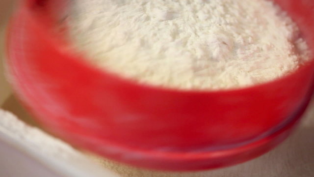 Housewife sift flour. Prepare a celebratory cake