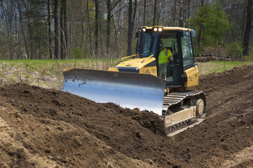 Bulldozer pushing dirt on construction site