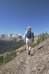 Woman Hiking On A Mountain Trail