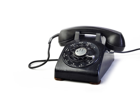 Vintage black telephone on white background with copy space