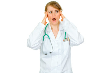Shocked medical doctor woman looking at copy space