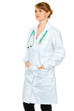 Pensive medical doctor woman looking at copy space