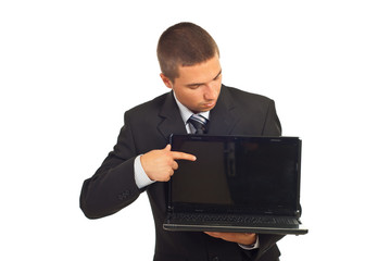 Businessman pointing and looking to laptop screen