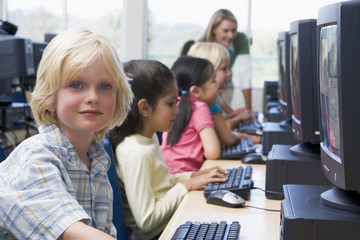 Kindergarten children learning how to use computers.