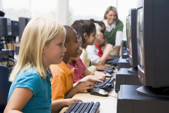 Kindergarten children learning how to use computers.